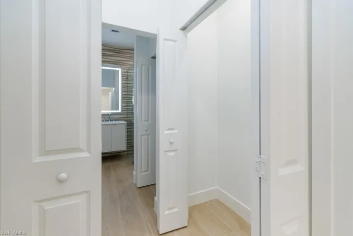 Corridor featuring baseboards and light wood-style flooring