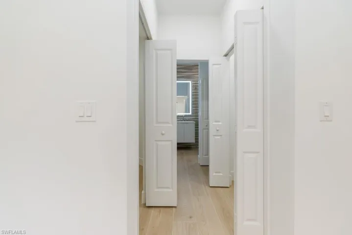 Hallway with light wood-style floors