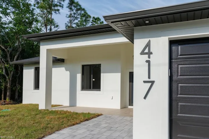 Property entrance featuring stucco siding