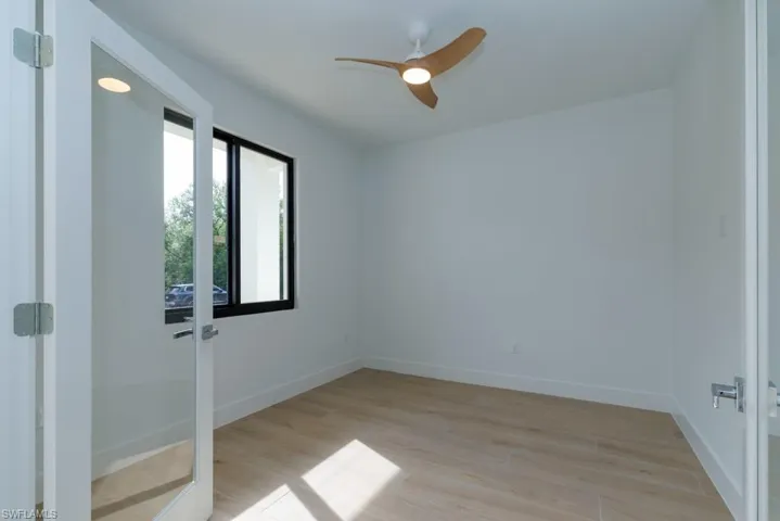 Empty room with baseboards, ceiling fan, and light wood-type flooring