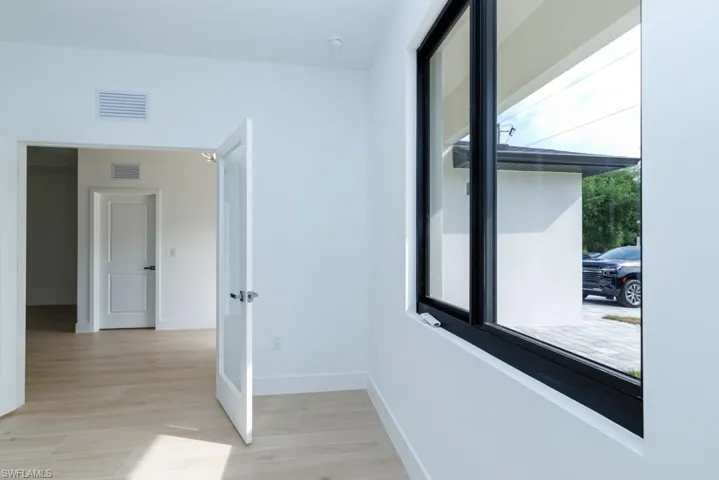 Spare room with baseboards, visible vents, and light wood-style flooring