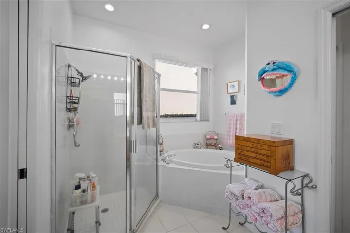 Bathroom featuring separate shower and tub and tile patterned floors