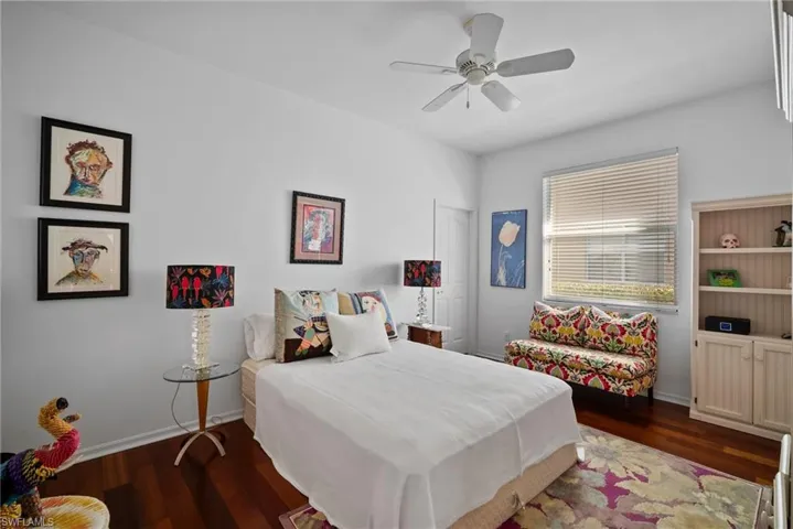 Bedroom with dark wood-type flooring and ceiling fan