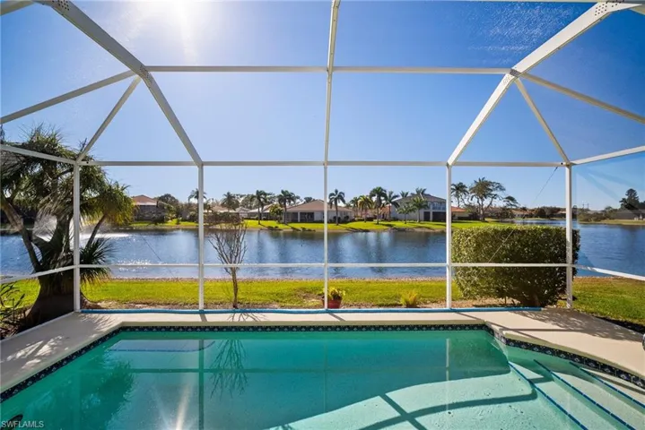 View of pool featuring a lanai, a patio area, and a water view