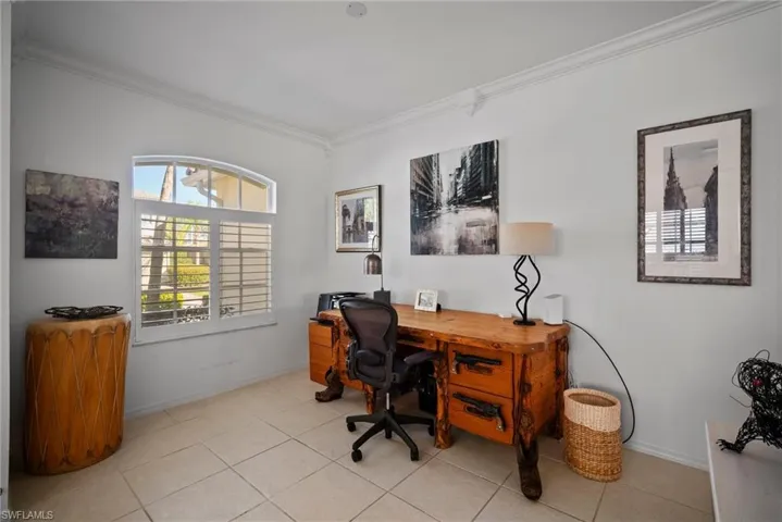 Tiled office space featuring crown molding