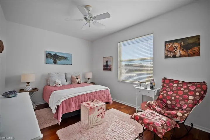 Bedroom featuring dark hardwood / wood-style flooring and ceiling fan