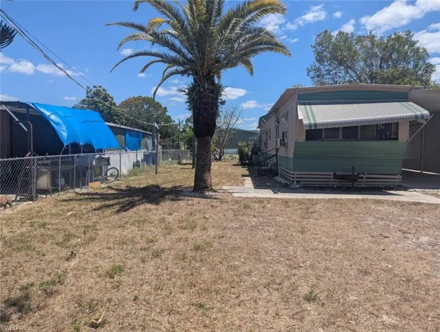 View of yard with entry steps and fence