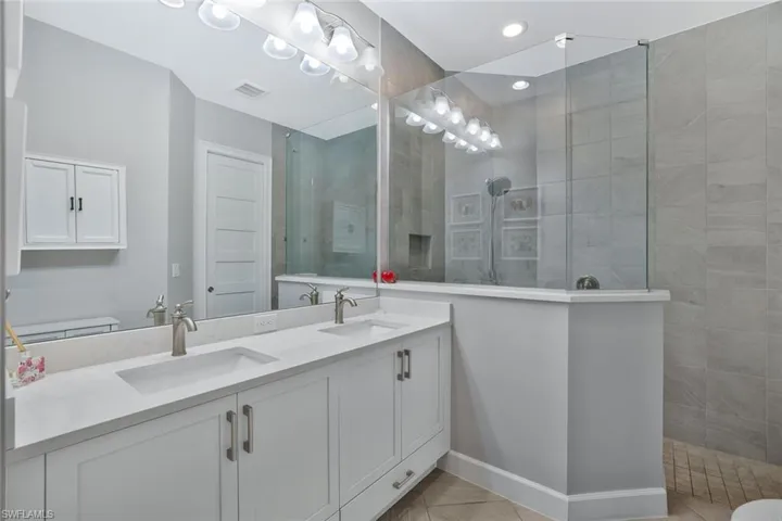 Bathroom with double vanity and a walk in shower