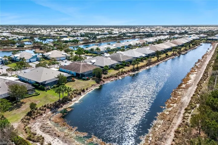 Aerial view of residential area featuring a nearby body of water