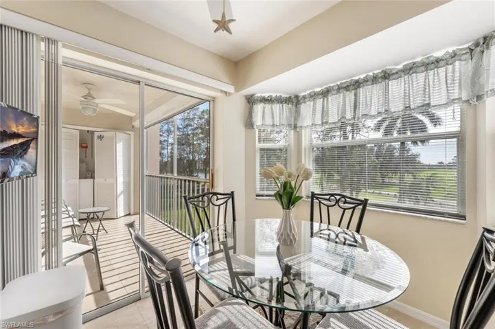 Dining area featuring light tile patterned floors and ceiling fan