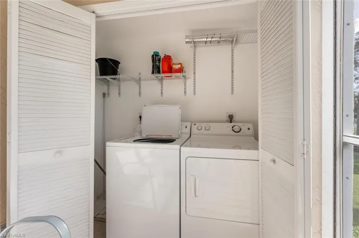 Clothes washing area featuring washing machine and dryer