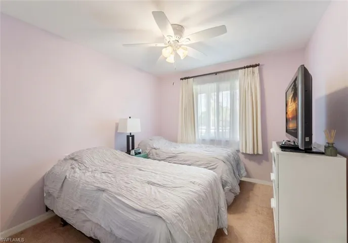 Carpeted bedroom with ceiling fan