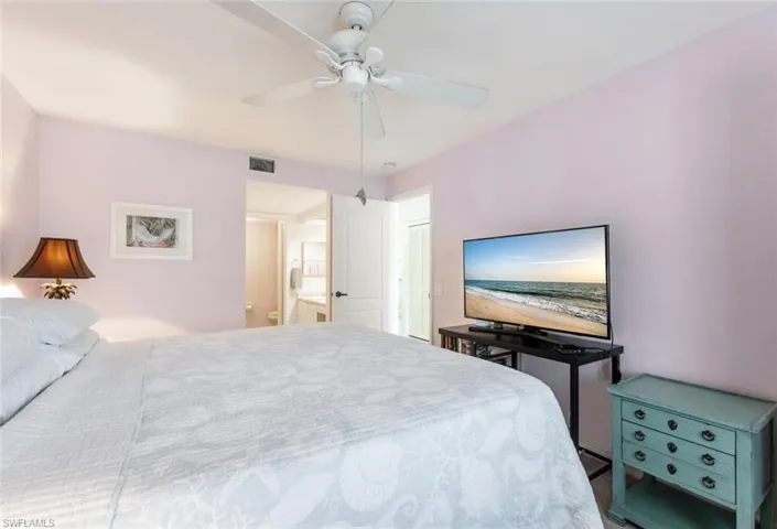 Bedroom with ceiling fan and ensuite bathroom