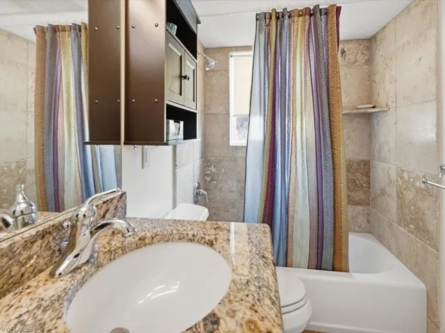 Bathroom with vanity and shower / tub combo
