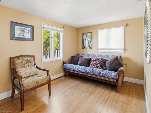 Living area with hardwood / wood-style floors and a textured ceiling