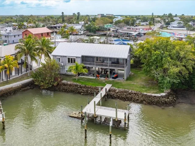 Aerial view of residential area featuring a nearby body of water