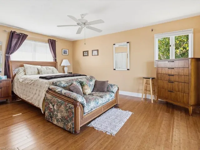 Bedroom with light wood finished floors and ceiling fan