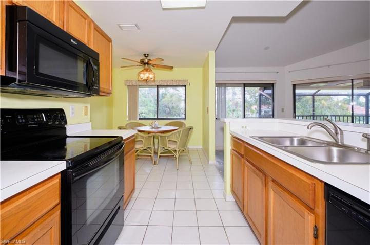 Open kitchen with wood cabinetry.