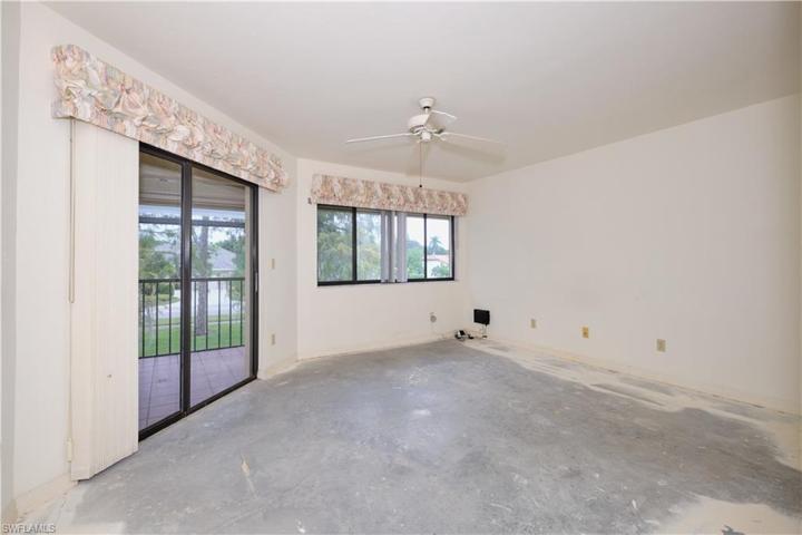 Owners suite features a sliding glass door out to the screened patio.