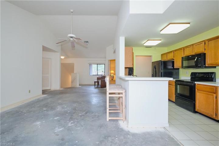 Open floor plan with volume ceiling.
