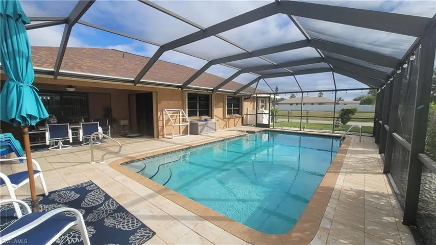 View of swimming pool featuring a lanai and a patio