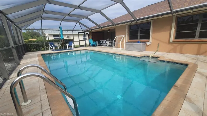 View of pool with a patio area and a lanai