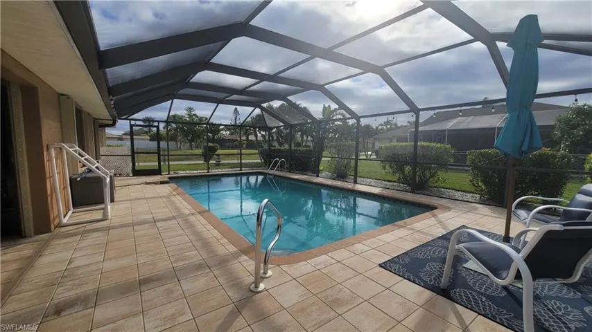 View of swimming pool featuring a lanai and a patio