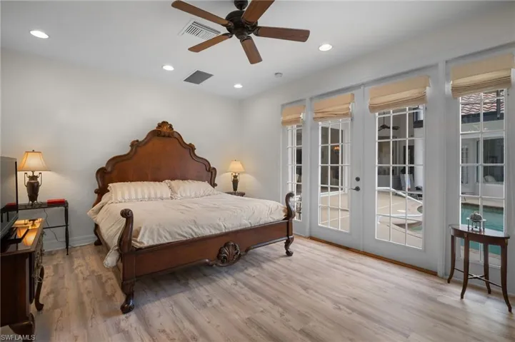 Bedroom featuring light wood finished floors, access to exterior, french doors, recessed lighting, and a ceiling fan