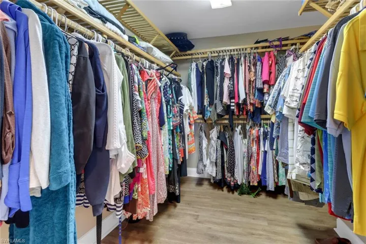 Walk in closet featuring wood finished floors