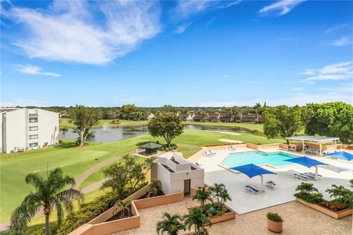 Community pool with view of golf course, a water view, a patio area, and a vegetable garden