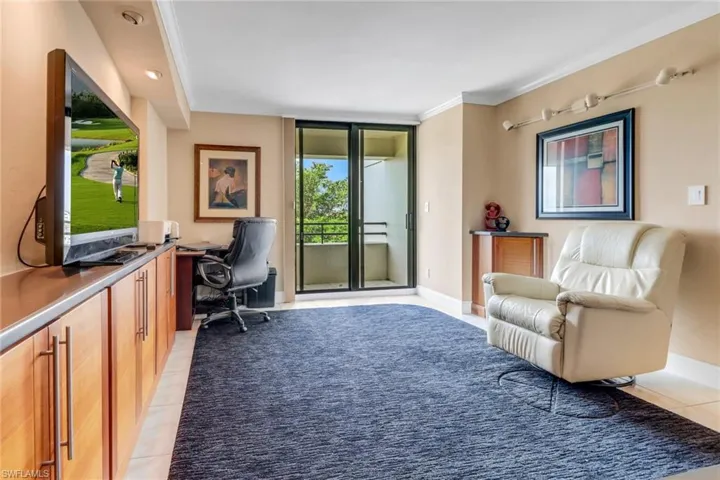 Office featuring light tile patterned floors, ornamental molding, and baseboards