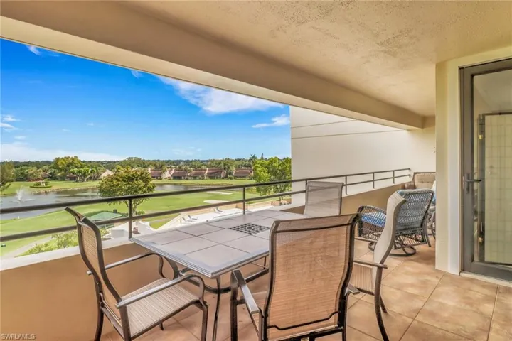 Balcony featuring a water view and golf course view