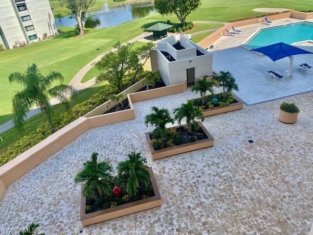 Bird's eye view of a large body of water, a local golf course, and a pool area