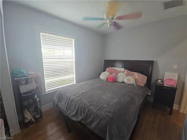 Bedroom featuring dark wood-type flooring and a ceiling fan