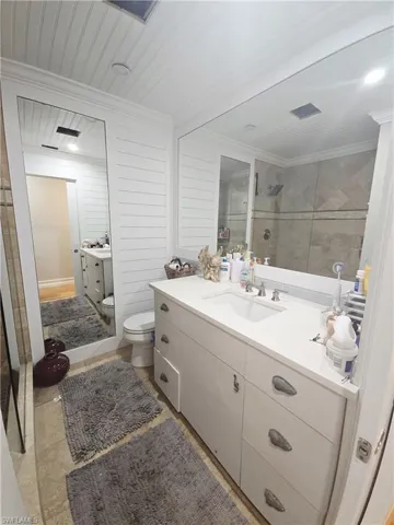 Bathroom with vanity, a tile shower