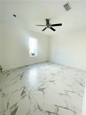 Unfurnished room featuring a ceiling fan