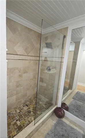 Full bath featuring walk in shower and crown molding