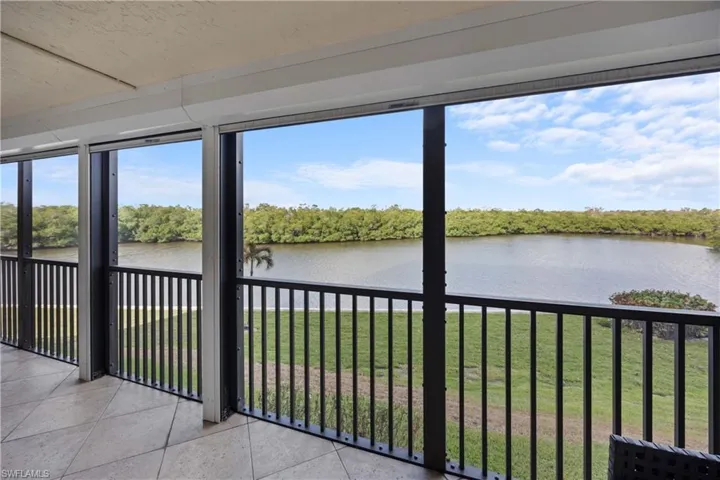 Unfurnished sunroom featuring a water view