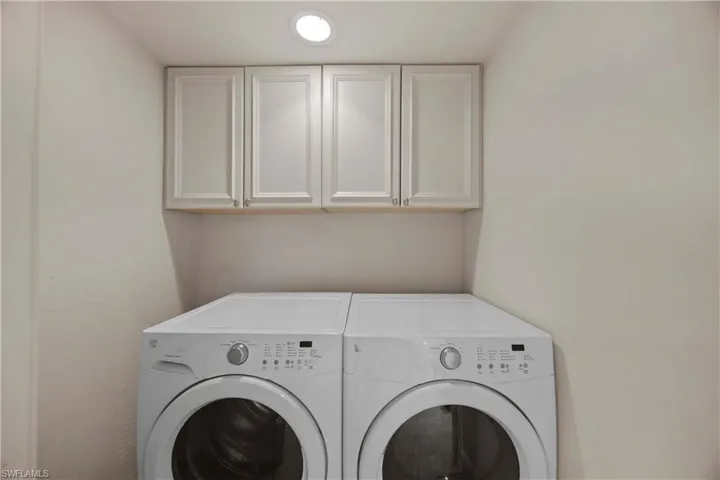 Laundry room with cabinets and washing machine and dryer