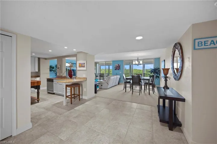 Tiled dining area featuring sink and a chandelier
