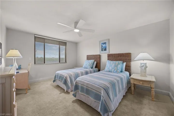 Carpeted bedroom with ceiling fan