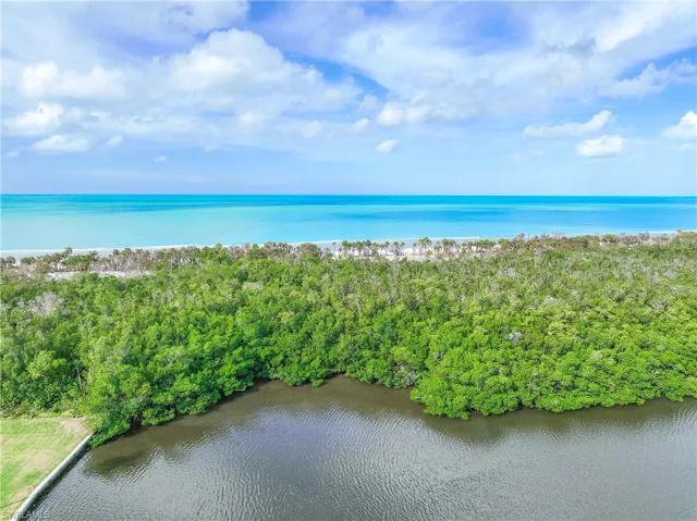Birds eye view of property with a water view