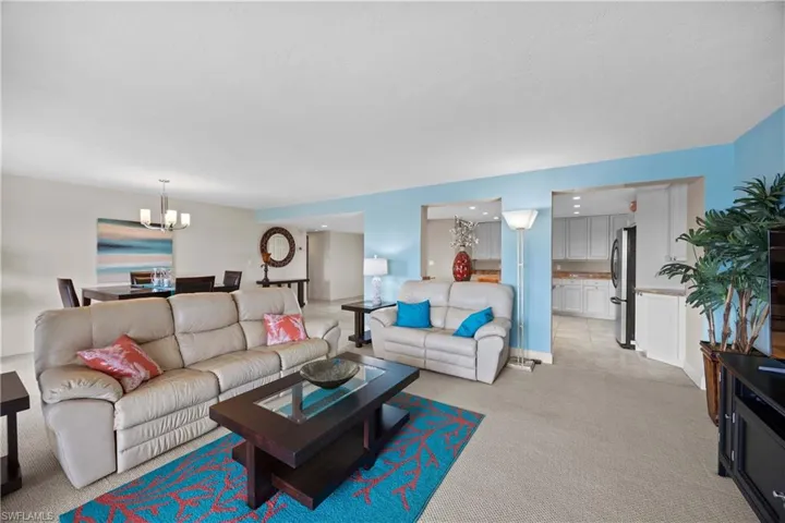 Living room with a chandelier and light colored carpet