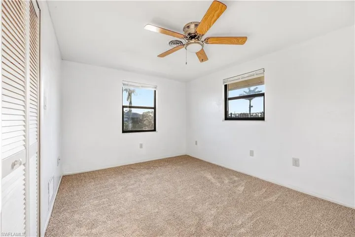 Unfurnished bedroom featuring carpet flooring, a closet, and ceiling fan