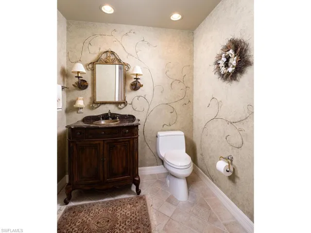 Half bath featuring vanity, recessed lighting, and light tile patterned floors