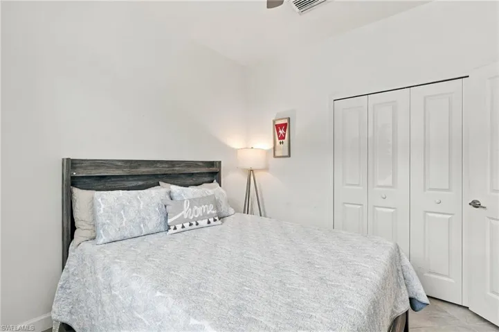 Bedroom 3: Tile flooring, a window with horizontal blinds, closet, and a ceiling fan