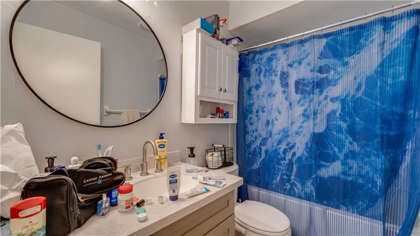 Full bathroom with vanity and shower / bath combo with shower curtain
