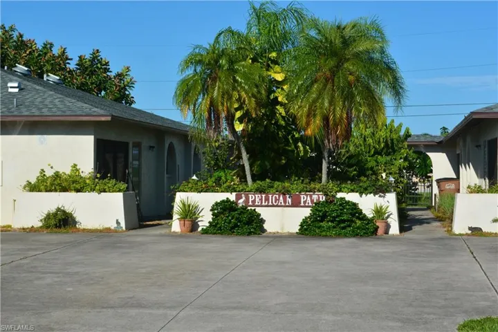 View of side of home featuring stucco siding and a shingled roof
