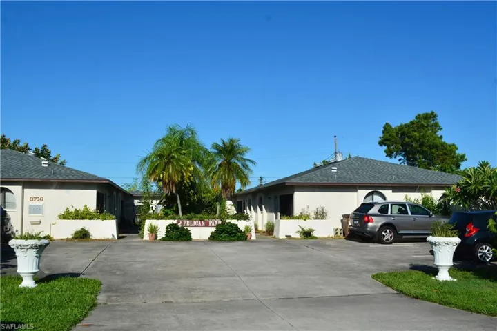 View of front of house with stucco siding and concrete driveway