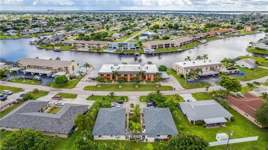 Aerial perspective of suburban area with a nearby body of water